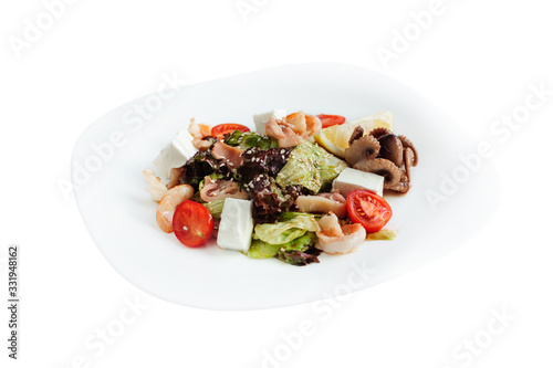 Fresh healthy salad with octopus, grilled shrimps, feta and vegetables.