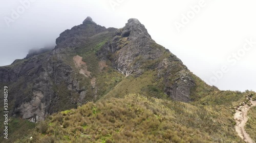 A long clip that shows the large grass typical for high places in the Andes and a large rocky mountain ridge of the Rucu Pinchincha
 photo