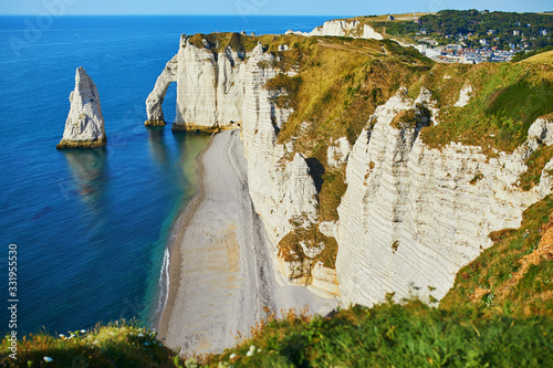 Picturesque panoramic landscape of white chalk cliffs and natural arches of Etretat