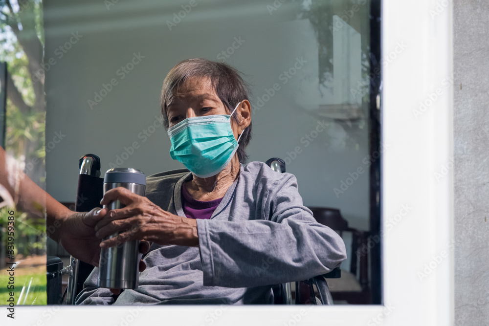 Elderly woman stay at home with son to help protect infection of coronavirus (COVID-19) from outside Elderly woman stay at home with son to help protect infection of coronavirus (COVID-19) from outside