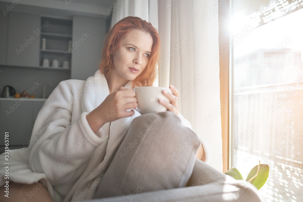stayhome concept, attractivewoman sitting in bed , holding cup of black coffee, enjoying peaceful calm weekend vacation morning time alone in bedroom at home or hotel. stayhome concept, attractivewoman sitting in bed , holding cup of black coffee, enjoying peaceful calm weekend vacation morning time alone in bedroom at home or hotel.