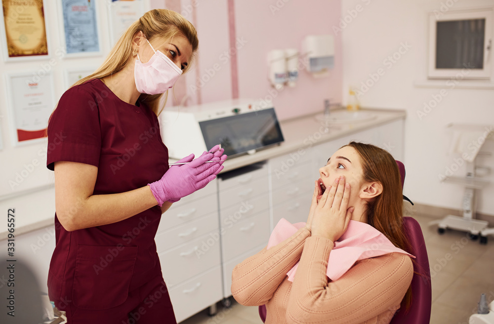 Little girl visiting dentist in clinic. Conception of stomatology Little girl visiting dentist in clinic. Conception of stomatology