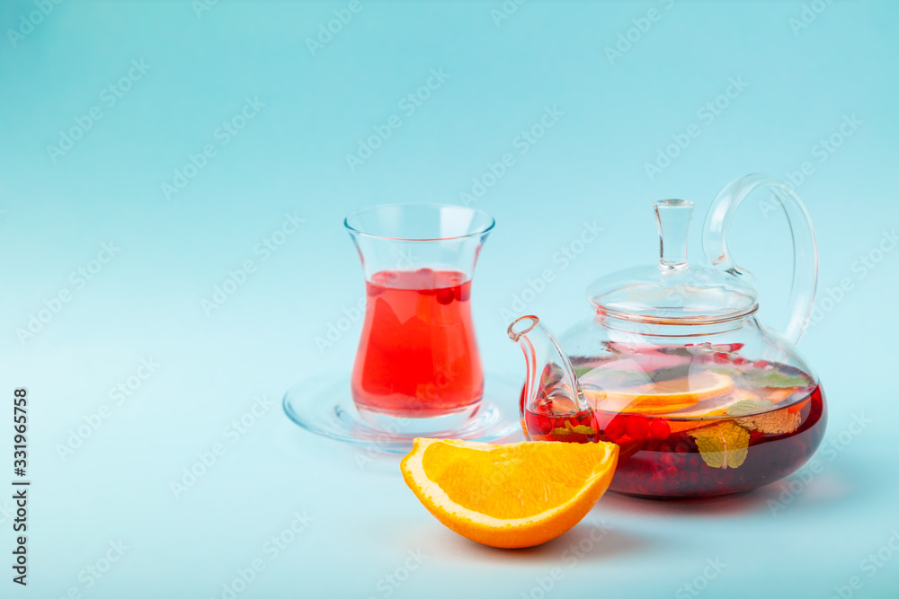 Fruit tea with berries in kettle, turkish shape tea cup Fruit tea with berries in kettle, turkish shape tea cup