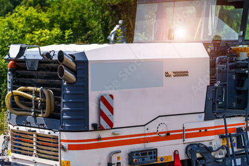 Tractor, roller on the road repair site. Road construction equipment. Road repair concept. Construction workers on road repair.