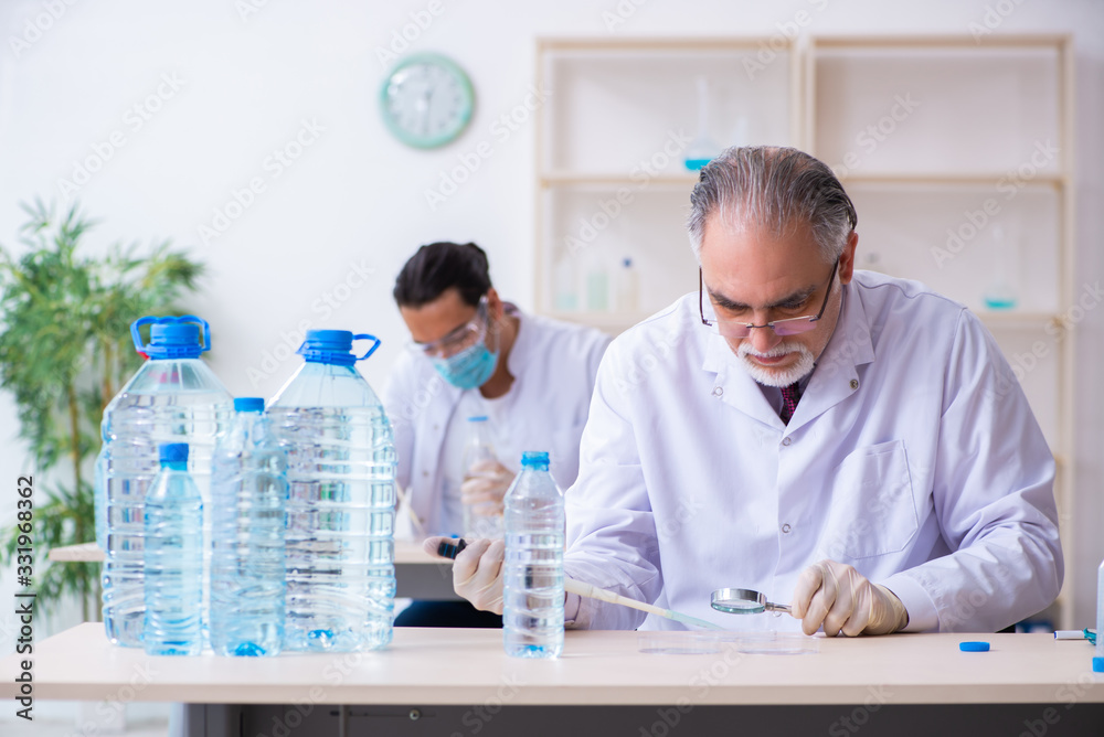 Two chemists working in the lab Two chemists working in the lab