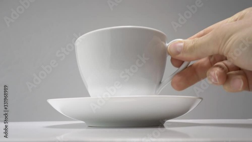 Steam rises from a cup of hot coffee. Grey background