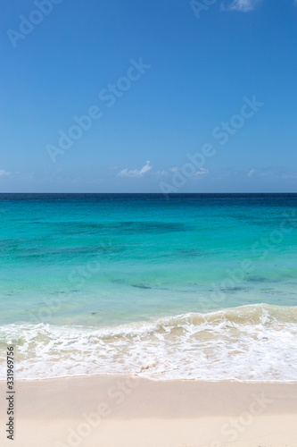 Fototapeta Naklejka Na Ścianę i Meble -  Looking out over a turquoise ocean with a blue sky overhead, on the Caribbean island of Barbados