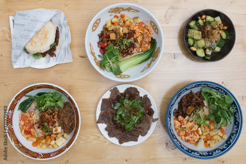 Set of food and dishes of vegetables, meat and fish on wooden background. Top view.