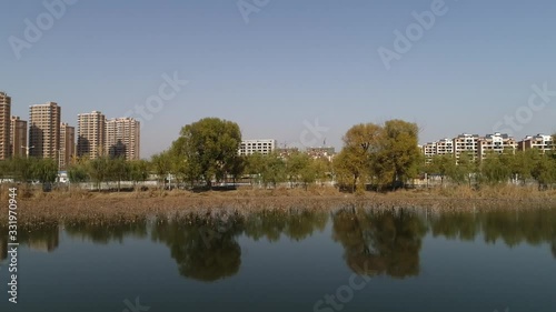 Waterfront, city, architecture, scenery, river, lake, water surface, aerial photography, overlooking, dynamic, landscape, beautiful, modern, autumn, nature, environment, city, green, high-rise buildin photo