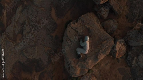 Top view of a lone astronaut on Mars. The astronaut lies on the surface of the planet Mars. Astronaut on the red planet.