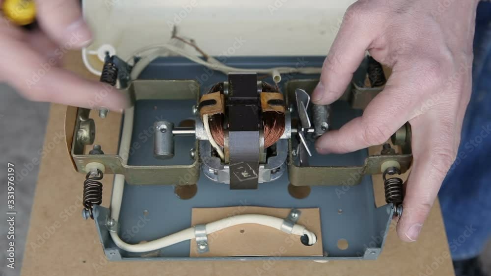 A man is repairing an electrical appliance. A man is repairing an electrical appliance.