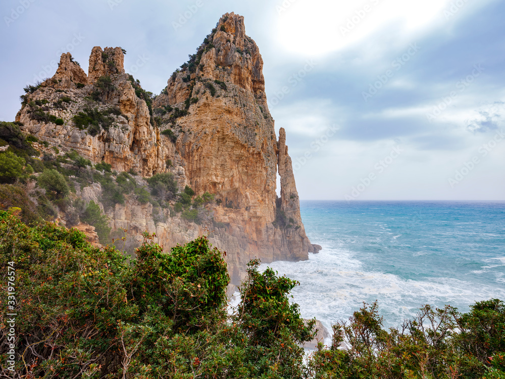 Pedra Longa, an impressive limestone cliff in the beautiful region of Ogliastra, Sardinia. It is an natural monument, reachable through a small paved road or a coastal path.