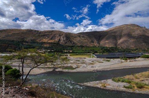 mining debris in the santa river in callejon de huaylas with snowy mountain in the background photo