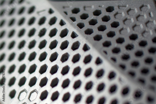 Metal perforated sheet, background with circles. Texture plastic with hole. © Vlyaks