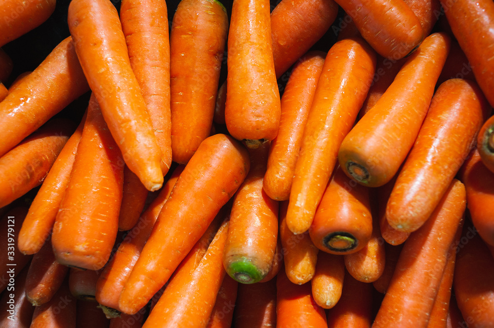 Plenty of fresh orange carrot on a counter in a market Plenty of fresh orange carrot on a counter in a market
