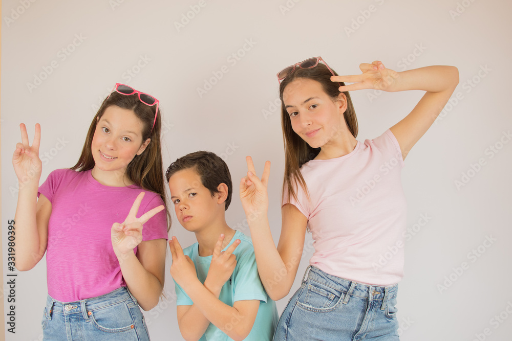 Boy and girls making gestures to the camera Boy and girls making gestures to the camera