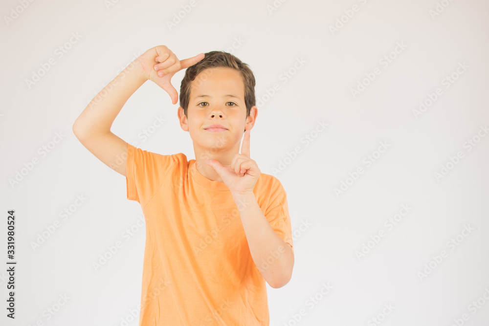 Boy making gesture and looking into camera Boy making gesture and looking into camera