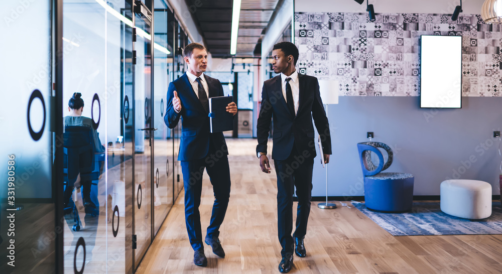 Multiethnic office workers having conversation on break at office Multiethnic office workers having conversation on break at office