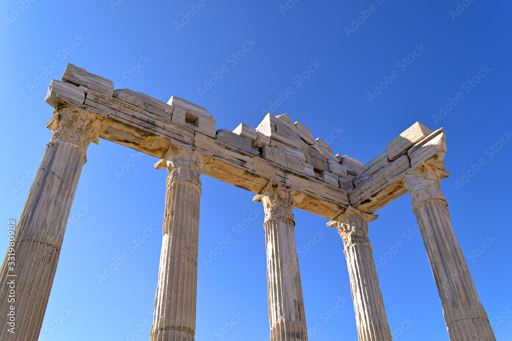 antique columns in the old city of Side against the blue sky in Turkey, background for a copy of the space