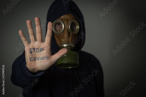 Man with antigas mask  makes gesture stop
