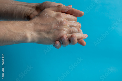 A man washes his hands with soap and uses an antiseptic to clean and disinfect his hands. Virus Prevention, Coronovirus. Hygiene concept hand detail.