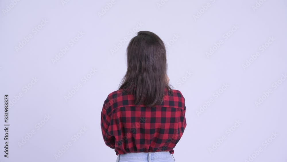 Rear view of young hipster woman directing and pointing finger Rear view of young hipster woman directing and pointing finger