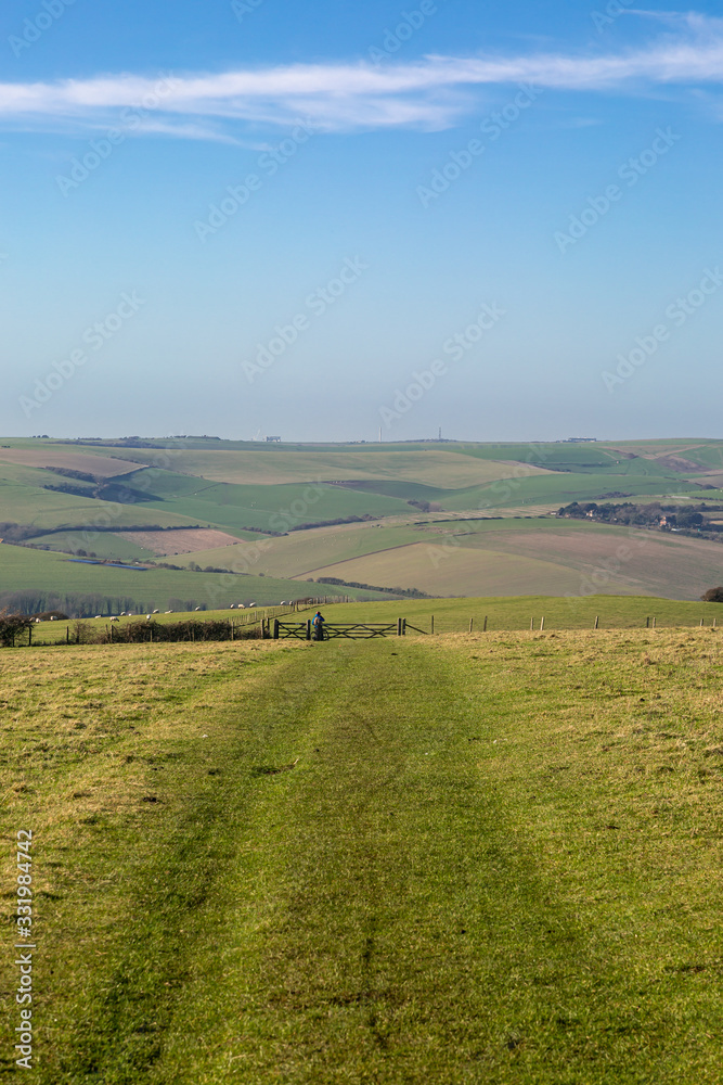 A pathway in the South Downs with a view of an idyllic Sussex landscape