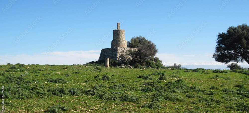 ancient stone tower in green field ancient stone tower in green field
