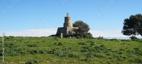 ancient stone tower in green field