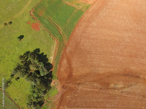 Aerial image taken with crop drone, one with plants and one with exposed soil and forest area