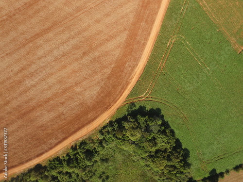 Aerial image taken with crop drone, one with plants and one with exposed soil and forest area