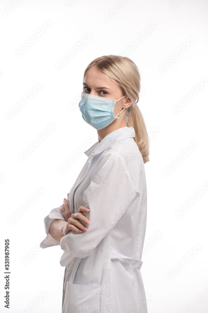 young beautiful girl with blond hair in a medical mask. On white background. Coronavirus