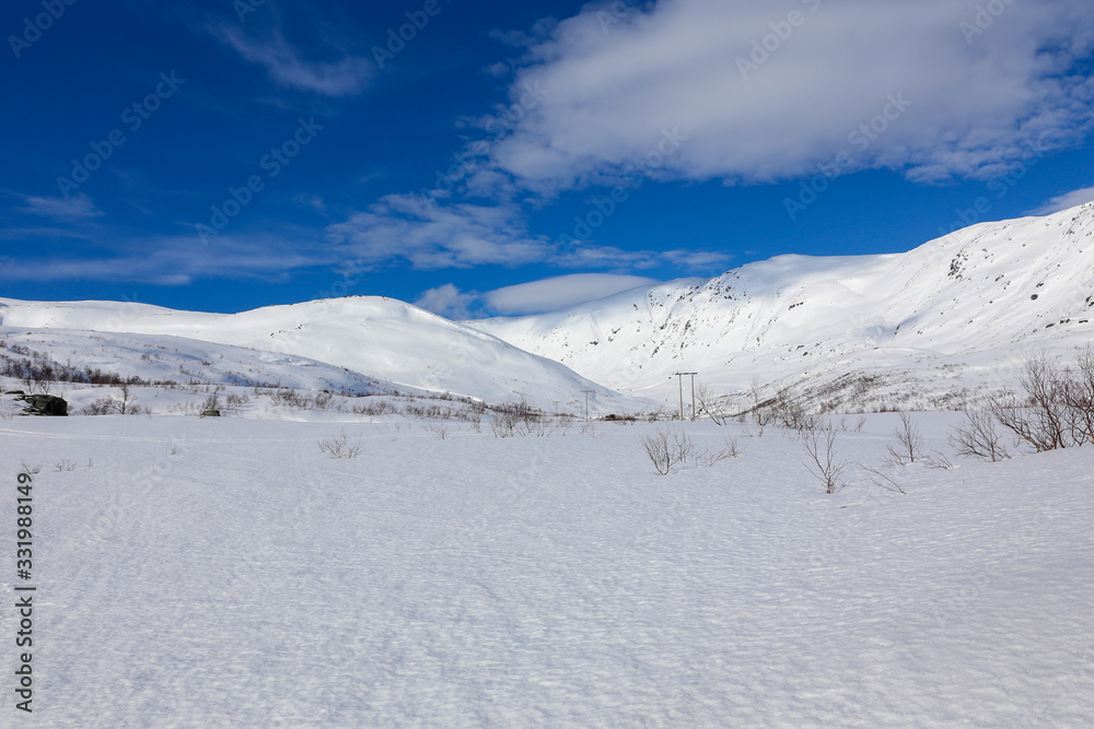 Winter and sun with great ski conditions on the Tosen mountain in Grane municipality, Northern Norway