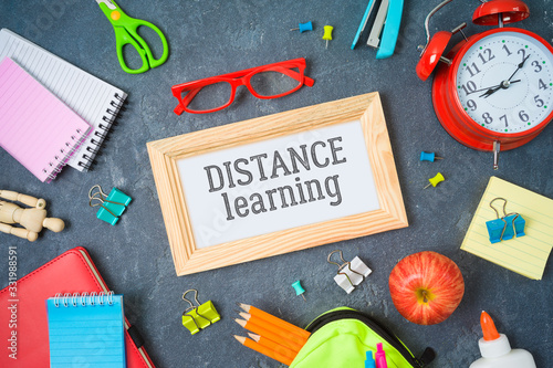 Distance learning and education concept. Study online from home with table and school supplies. Top view from above