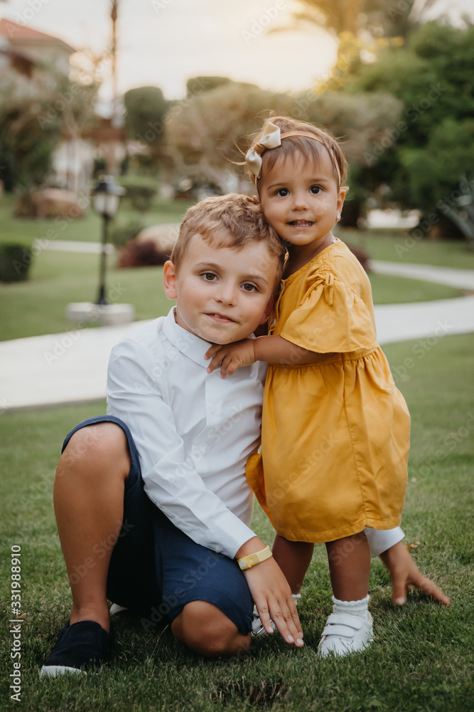 Fototapeta premium Two kids, brother and sister hugging