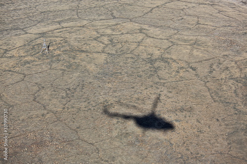 Helicopter shadow on tundra landscape in summer, Taymyr peninsula, aerial view