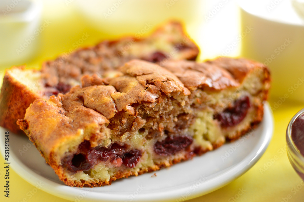 Cupcake with cherries for breakfast. Slice of cake with cherry and cocoa, closeup. Homemade pastries with berries. Cupcake with cherries for breakfast. Slice of cake with cherry and cocoa, closeup. Homemade pastries with berries.