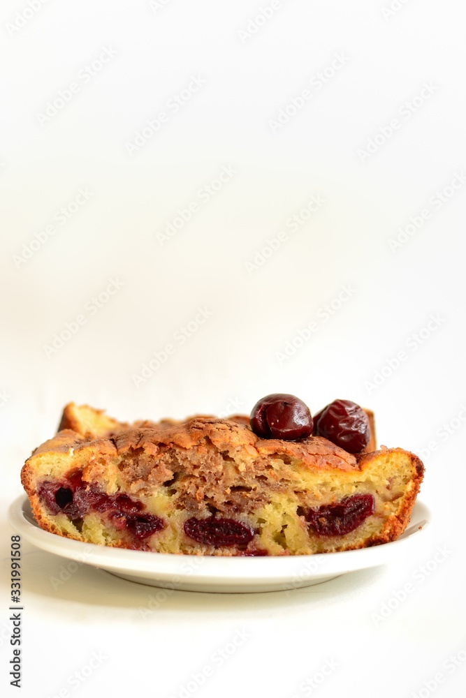 Cupcake with cherry on a white background, isolated. Slice of cake with cherry and cocoa, closeup. Tasty sweet breakfast, pastries. Cupcake with cherry on a white background, isolated. Slice of cake with cherry and cocoa, closeup. Tasty sweet breakfast, pastries.