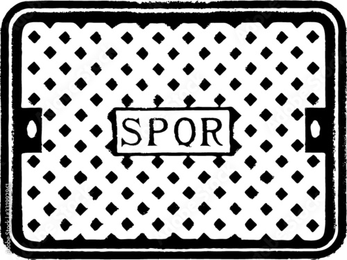 Rome, Italy - Characteristic iron manhole cover in the streets of the city of Rome, with the inscription SPQR (Senatus Populusque Romanus, 