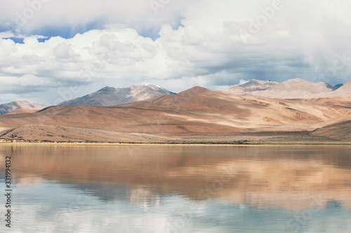 Himalayan mountains mirrored reflected in Tso Moriri mountain Lake water surface near Karzok or Korzok village in the Leh district of Ladakh, India.