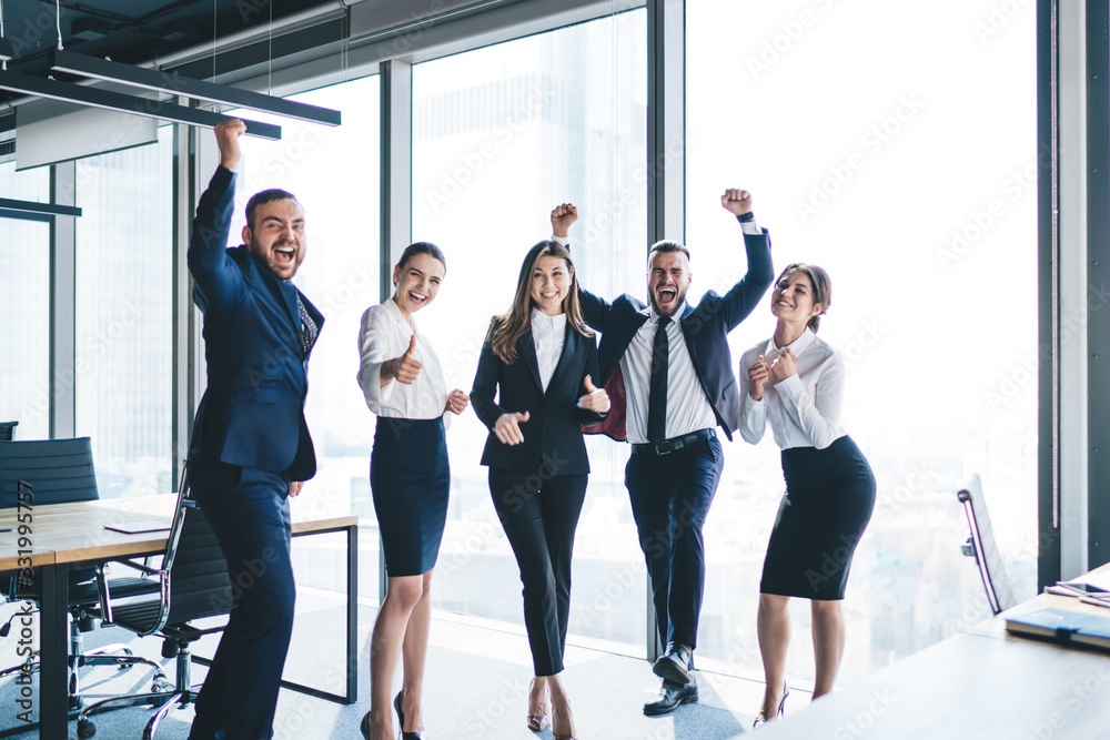 Fototapeta premium Overjoyed business team celebrating success in office