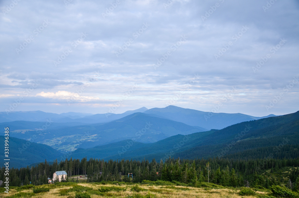 View from the mountain to the ski resort Dragobrat. Hoverla and petros mountines on background. Carpathian mountains, Ukraine