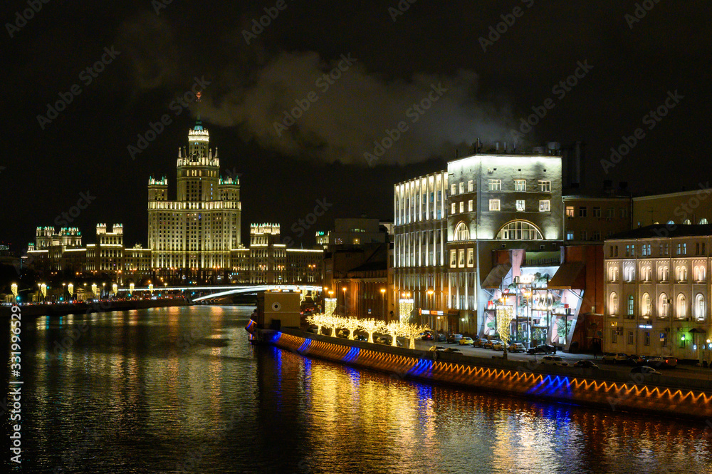 View of the Moscow River, Raushskaya embankment with New Year and Christmas decorations, a skyscraper on Kotelnicheskaya embankment, Moscow, Russian Federation, January 10, 2020