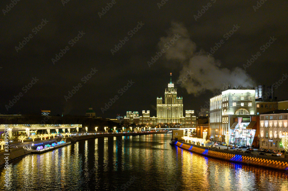 View of the Moscow River, Moskvoretskaya and Raushskaya embankments with New Year and Christmas decorations, a skyscraper on Kotelnicheskaya embankment, Moscow, Russian Federation, January 10, 2020