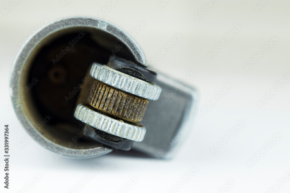 closeup and macro concept shot of the lighter and tinderbox on the white background