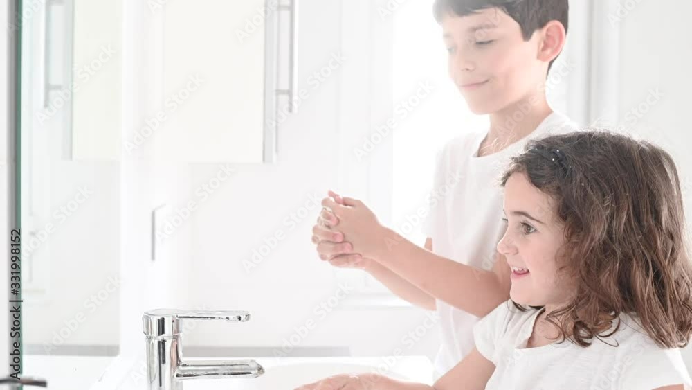 boy and girl washing their hands with soap to avoid contagion of the coronavirus boy and girl washing their hands with soap to avoid contagion of the coronavirus