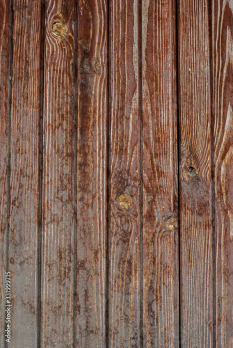 Shabby old fence of red-brown colour background of wooden boards, in the style of rustic, grunge, old fashion
