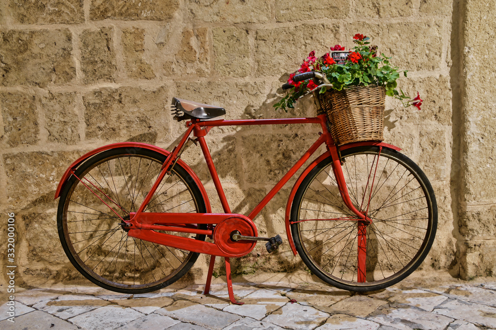 Old vintage bicycle with flowers in Puglia region in Italy