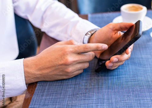 Person looking at his phone and tapping.