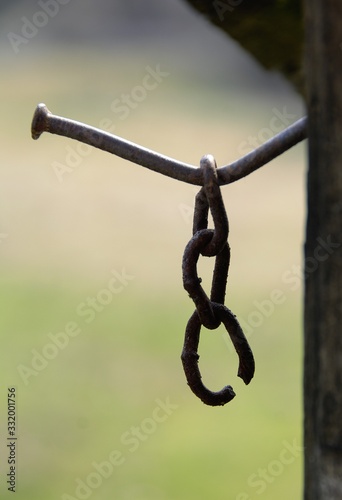 an old piece of chain hanging from a nail